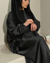 Load image into Gallery viewer, Full outfit view of black closed satin abaya styled for modest fashion