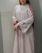 Load image into Gallery viewer, Full-length view of nude pink linen abaya with beautifully embellished sleeves