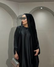 Load image into Gallery viewer, Close-up of piping detail on the black closed satin abaya fabric