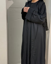 Load image into Gallery viewer, Side view of Eid abaya showing frayed sleeve with hand embellishment detail