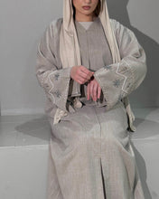 Load image into Gallery viewer, Back view of beige linen abaya showing modest cut and embellished sleeves
