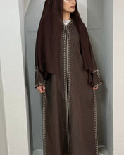 Load image into Gallery viewer, Back angle of chocolate abaya highlighting the modest fit and embroidery accents
