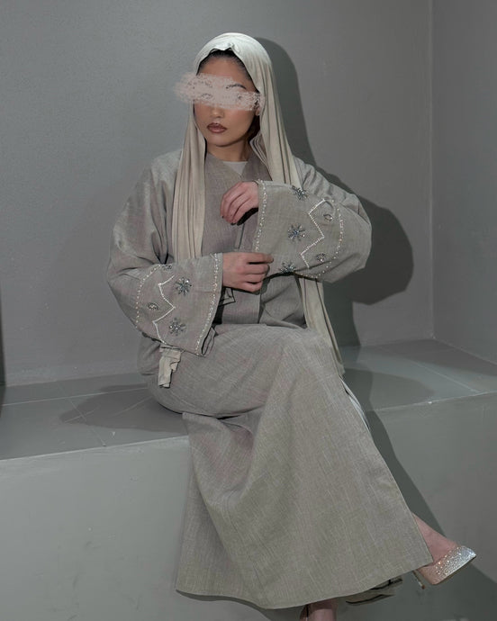 Front view of beige linen abaya with stunning handmade sleeve embellishments