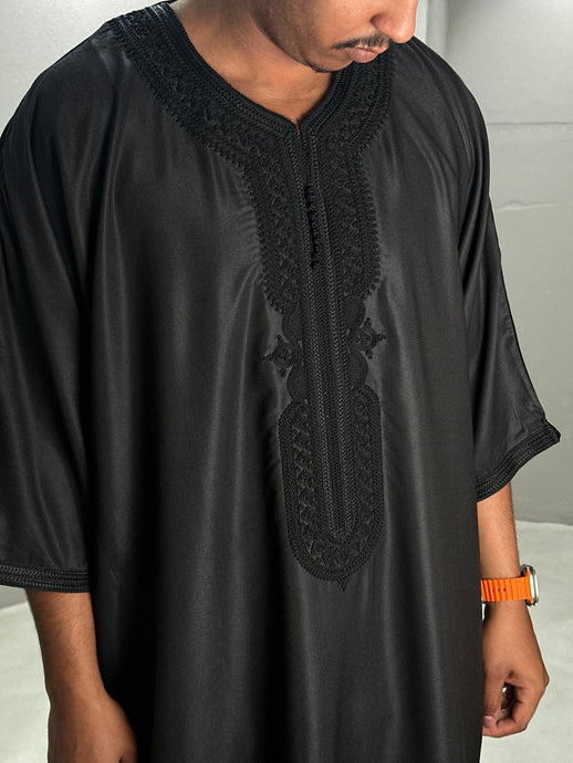 Front view of black Moroccan thobe showcasing traditional design