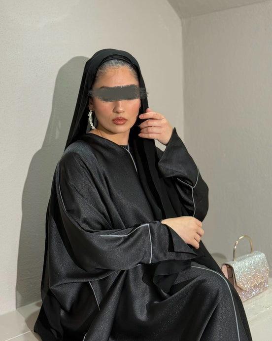 Front view of black closed satin abaya with elegant piping design