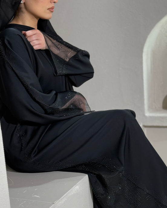 Front view of elegant lace abaya with see-through design, perfect for Eid wear