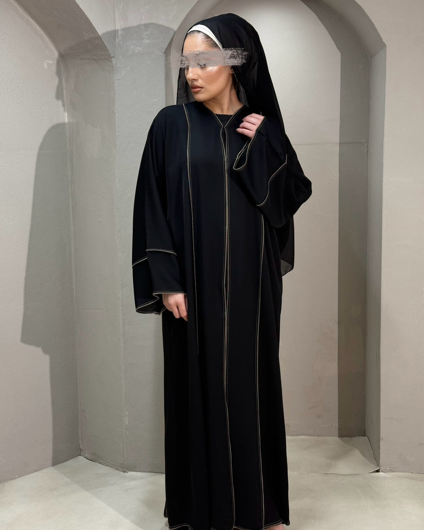 Elegant black abaya with bronze piping, perfect for a refined Eid look