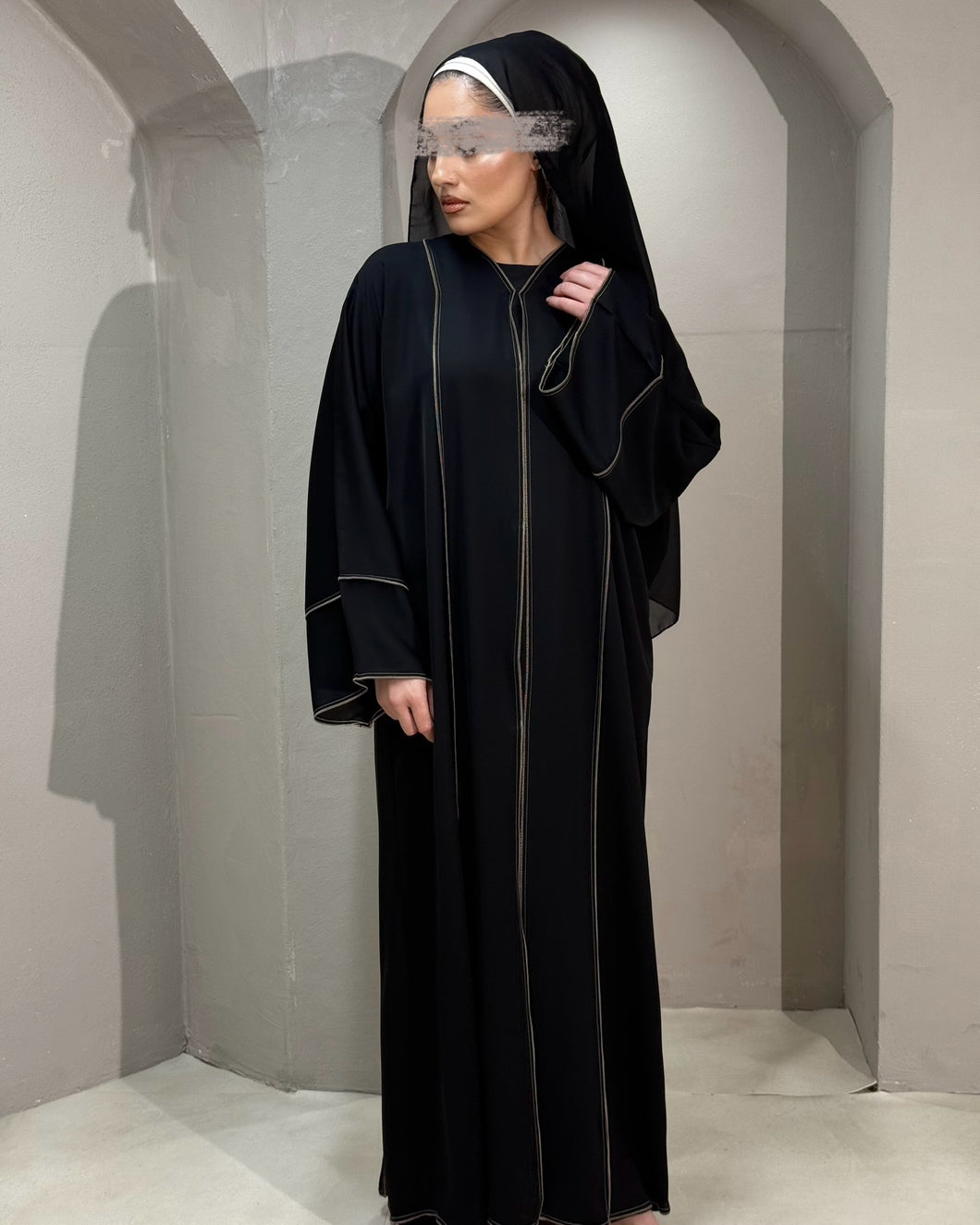 Elegant black abaya with bronze piping, perfect for a refined Eid look