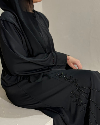 Front view of frayed embellished abaya from Eid collection with elegant details