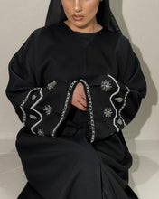 Load image into Gallery viewer, Side view of black linen abaya showcasing intricate handmade sleeve design
