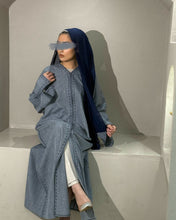 Load image into Gallery viewer, Model turning to display the split sleeves and structure of denim abaya
