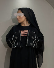 Load image into Gallery viewer, Model wearing black linen abaya featuring handcrafted embellishments on sleeves
