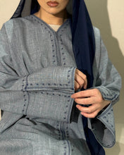 Load image into Gallery viewer, Side profile of denim abaya showing off split sleeves and soft drape
