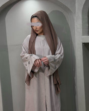 Load image into Gallery viewer, Side profile of nude pink abaya showcasing handcrafted sleeve embellishment
