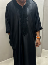Load image into Gallery viewer, Model in standing pose wearing black premium Moroccan thobe
