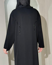 Load image into Gallery viewer, Close-up of collared design and buttons on embellished black abaya
