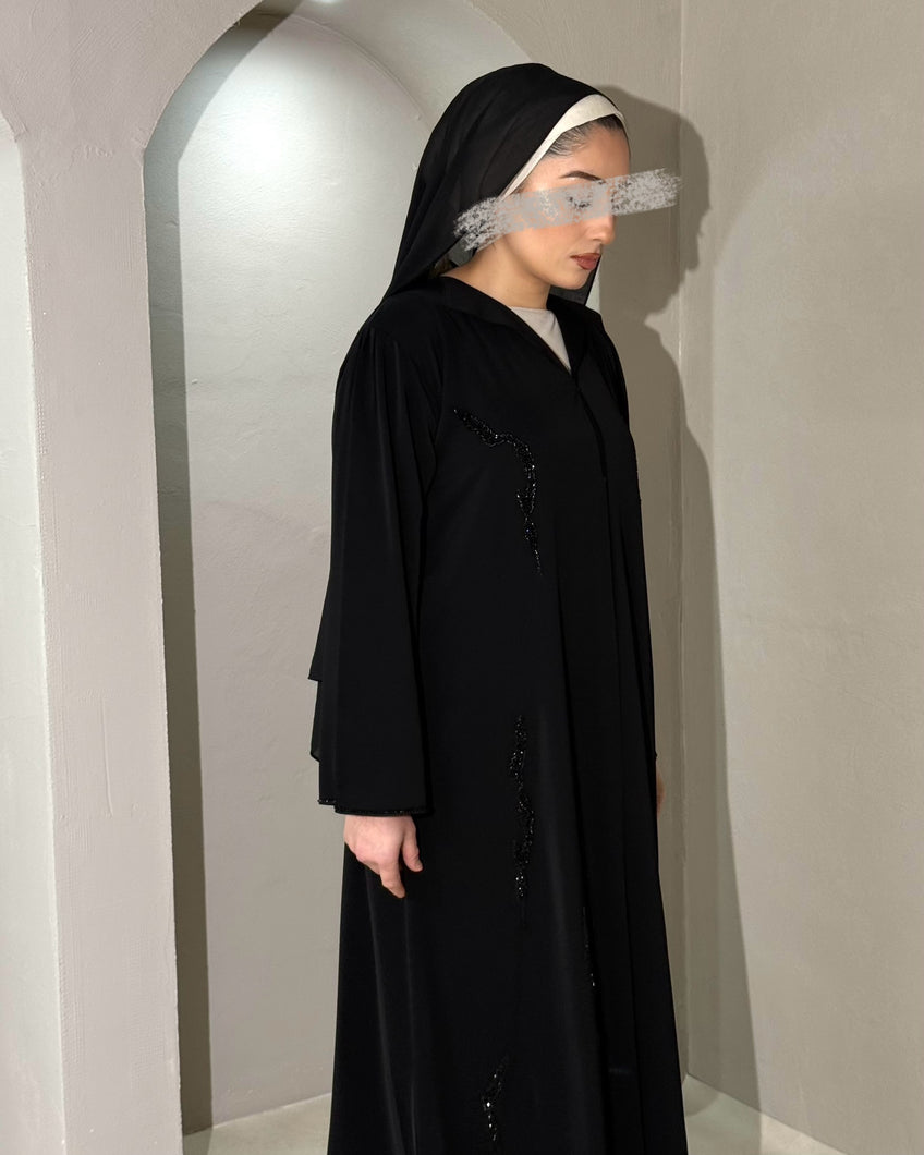 Front view of luxurious embellished black abaya with collared neckline