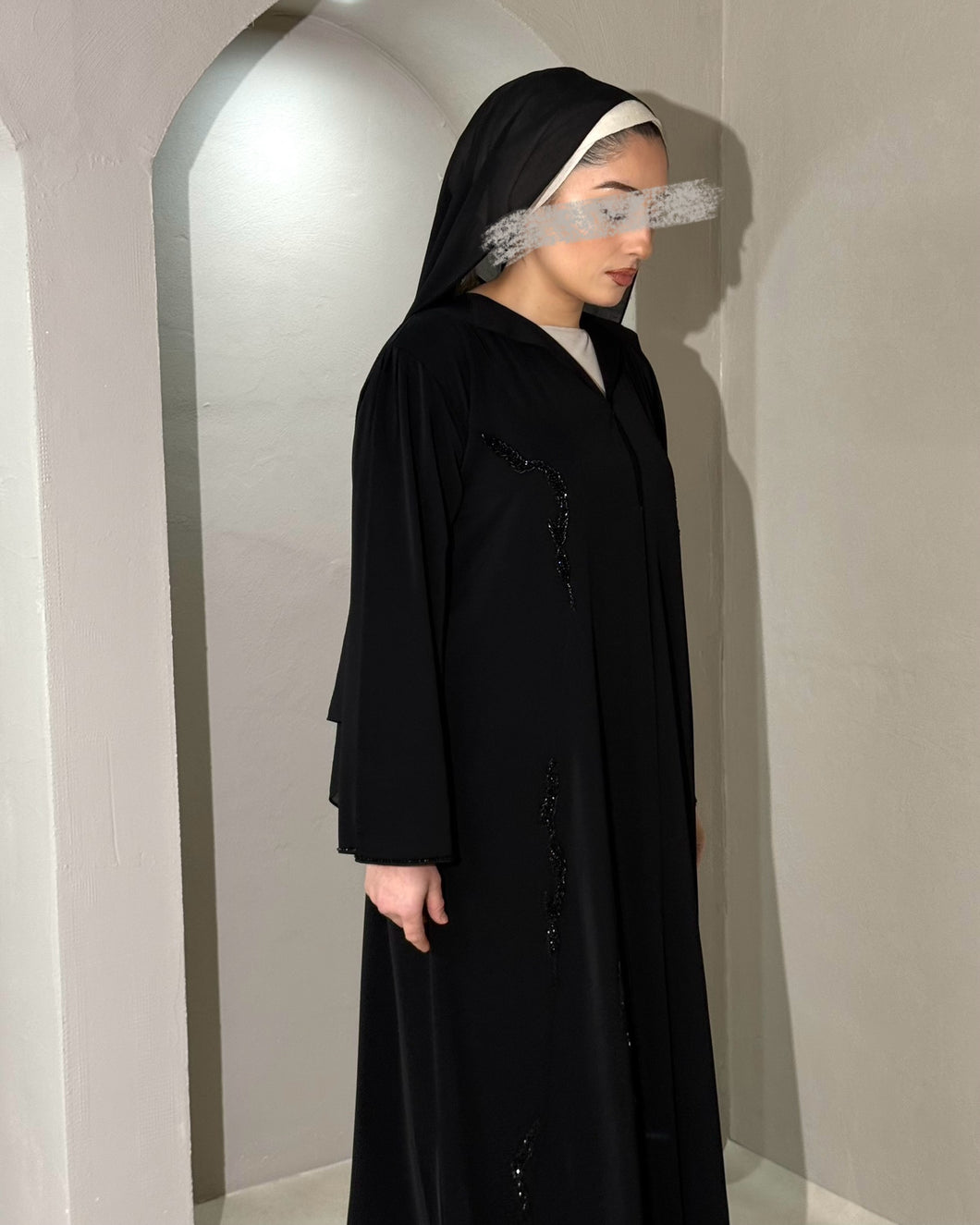 Front view of luxurious embellished black abaya with collared neckline